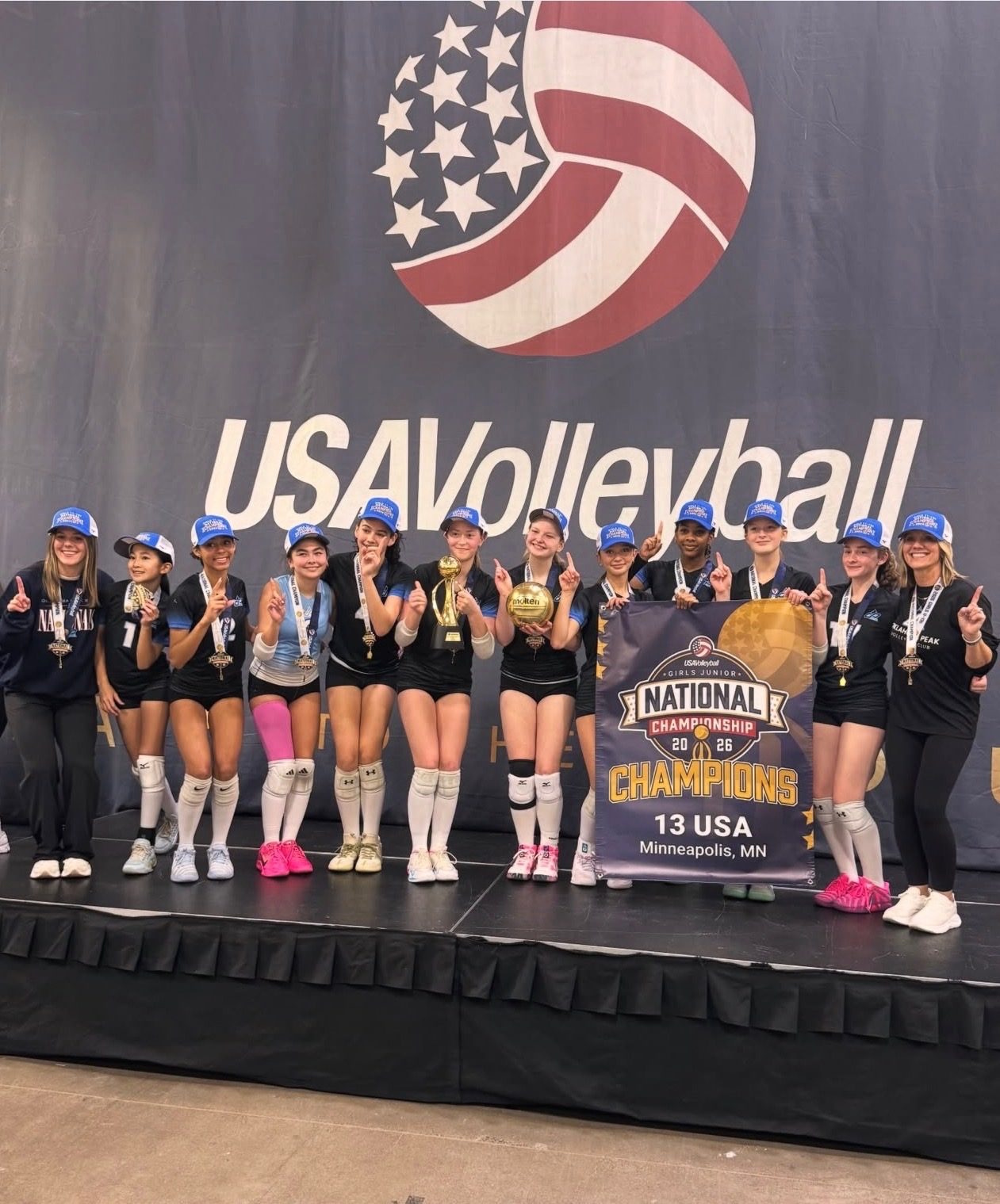 Oklahoma Peak 13 USA team celebrating their 2026 USA Volleyball Girls Junior National Championship win in Minneapolis, MN